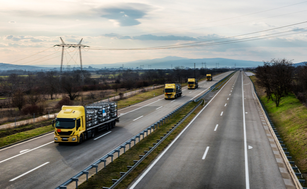 fleet trucks on the road in a rural area